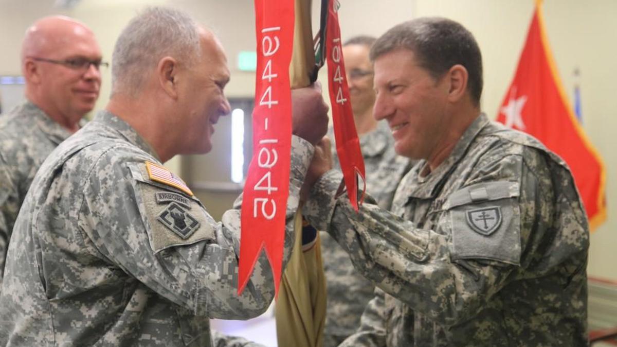 Maj. Gen. Mark Palzer, right, passes the 451st Expeditionary Sustainment Command’s colors to the unit’s new commander, Brig. Gen. Bruce Hackett during a Jan. 26 ceremony in Camp Parks, Calif. By passing the colors, Palzer entrusts Hackett with the responsibility, care and legacy of the command.