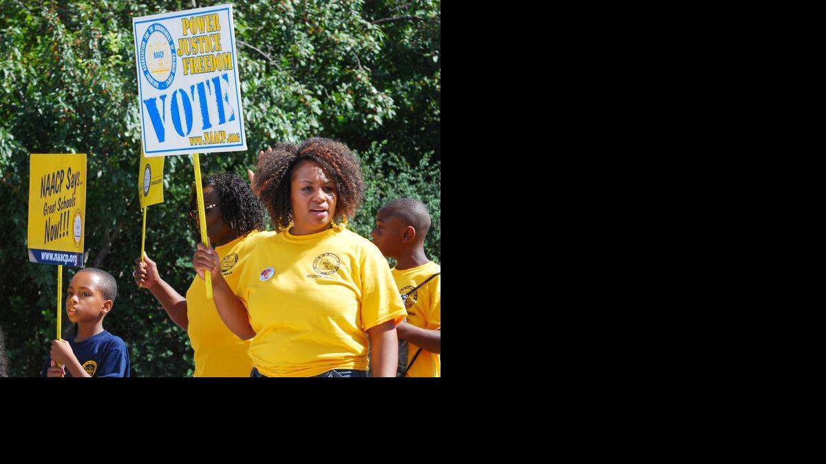 
Marchers representing the NAACP took part in the Black Arts Festival parade Saturday morning on 17th Street near Wichita State University. (Aug. 30, 2014)
