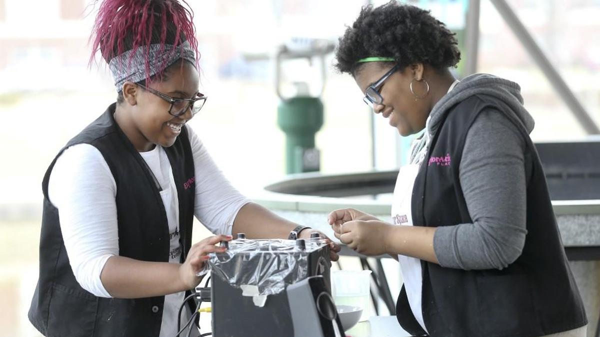Northeast Magnet student Devyn Fields, left, and East student Kamaria Cozart do a demonstration on sound at Exploration Place in March 2016. Students volunteered over spring break during United Way’s Youth Days of Caring.