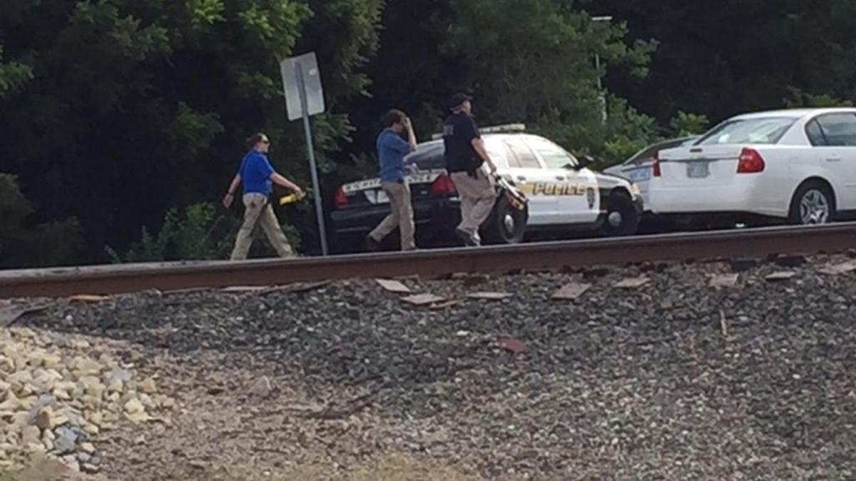 
Law enforcement officers search Monday afternoon near 55th Street South and K-15 for missing 5-month-old Vincent D. Moore. (Aug. 3, 2015) 
