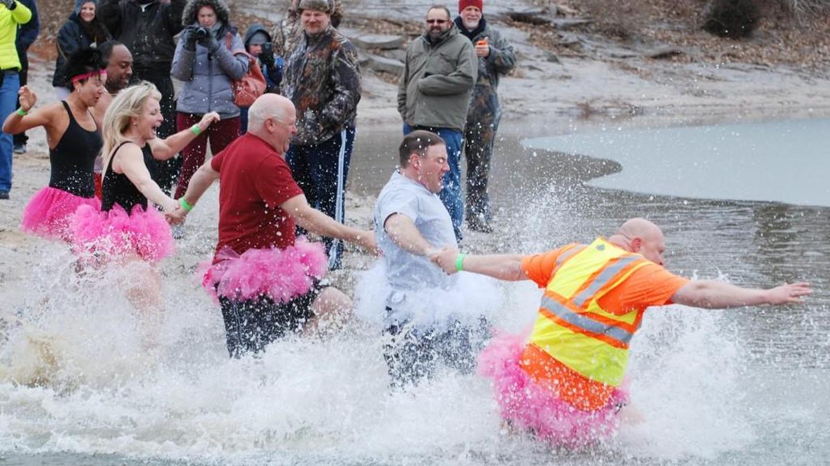 Costumed contestants enter the water at O.J. Watson Park during the annual Polar Plunge in 2014.