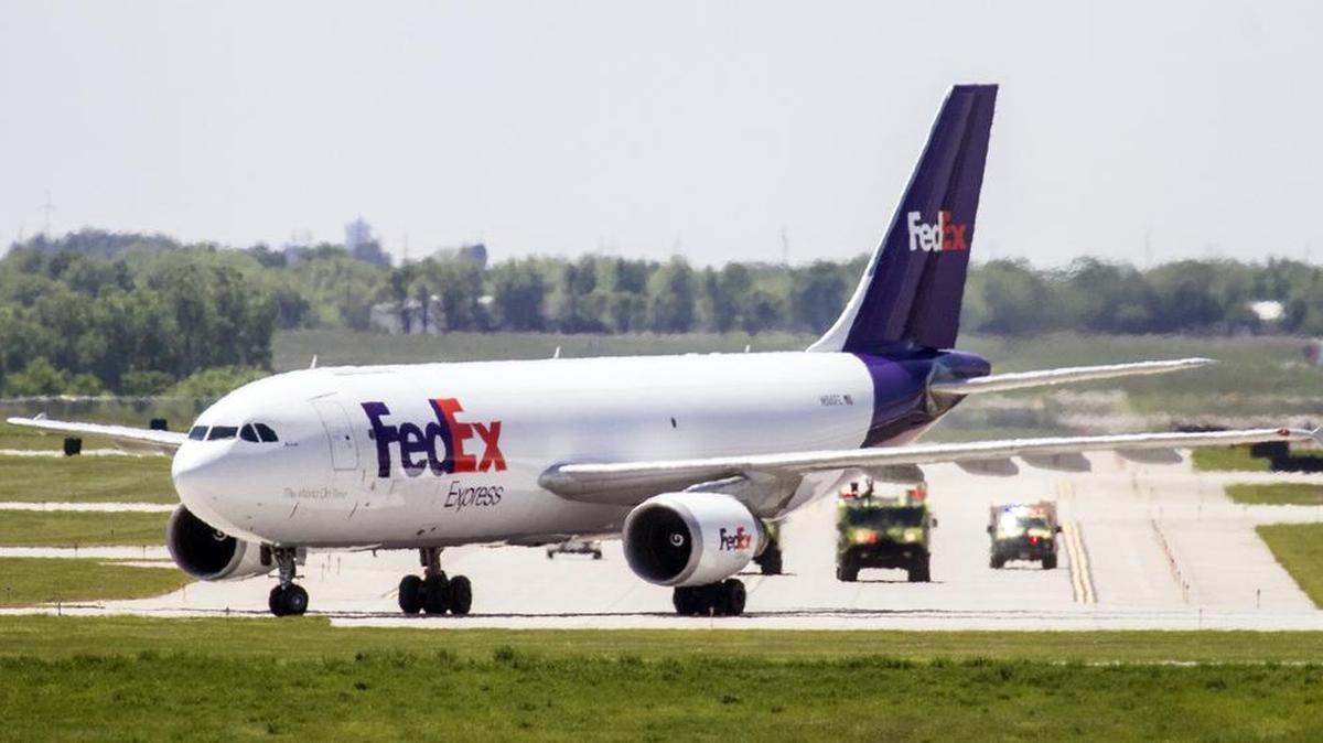 A FedEx cargo plane is escorted by Eisenhower National Airport emergency crews following an unscheduled landing Tuesday afternoon. (May 3, 2016)