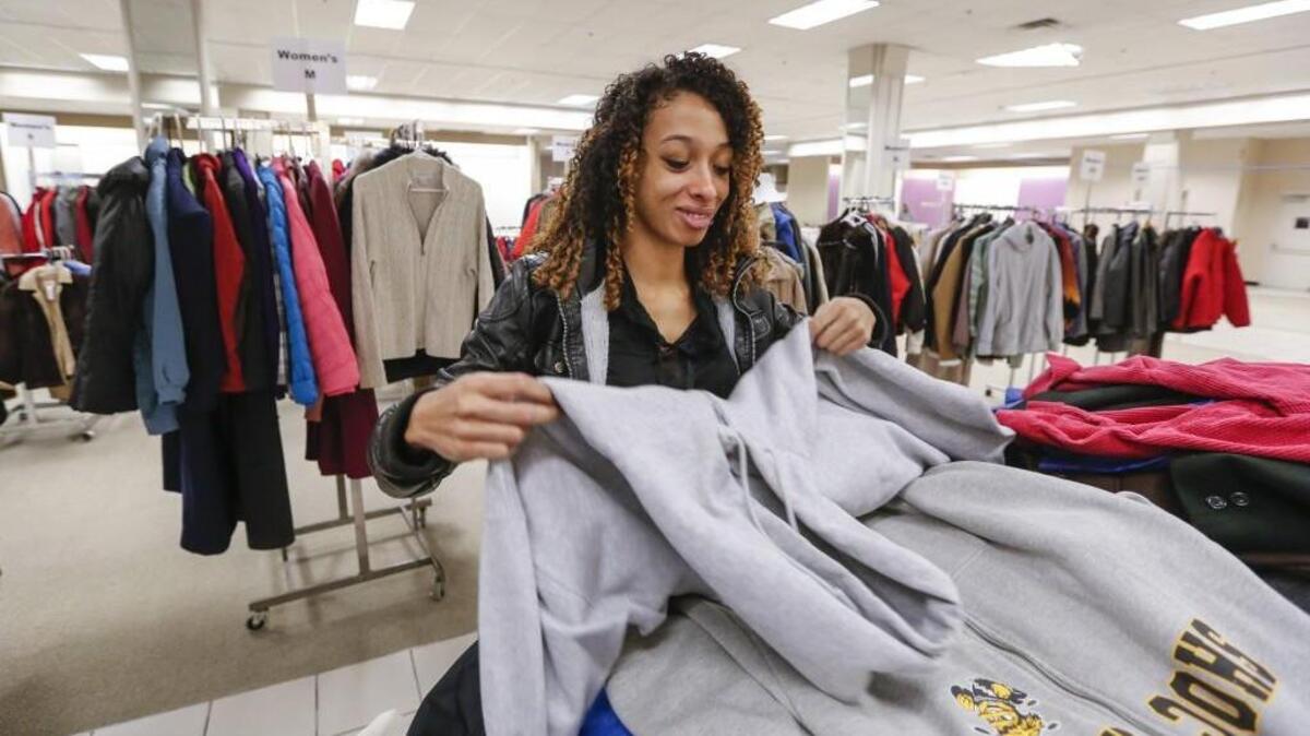 Ashley Davis sorts through donated coats at Operation Holiday in Towne West Square on Wednesday. Many organizations receive the bulk of their donations during this time of year.