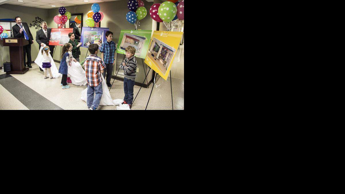 
Children unveil artist renderings of Wesley Medical Center's children's hospital during an announcement Thursday afternoon. The yet-to-be-named hospital is a complete renovation of Wesley's pediatric areas including a new exterior and a all-private 15-bed Pediatric Intensive Care Unit. (Feb 5, 2015)
