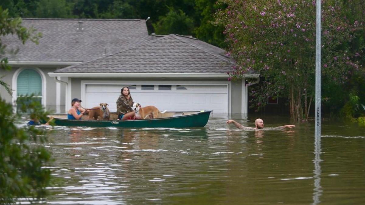 Family members evacuate their home in Houston on Aug. 27.