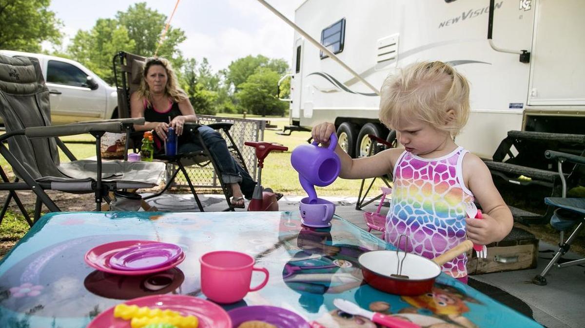 Dena Cox of Norwich watches her daughter Paisley, 2, pour a cup of tea while camping at Cheney State Park.