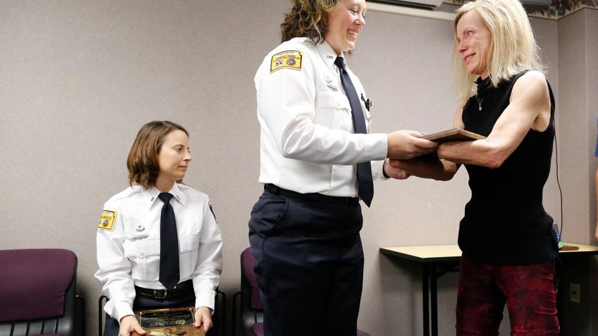 Julie Dombo, right, this year’s Wichita Crime Commission “Citizen Hero,” presents a plaque to Sharde Hornberger during a ceremony at Wesley Medical Center in May. Dombo had to have her hands and feet amputated after she was shot by an armed robber at a store in Derby in August 2015.