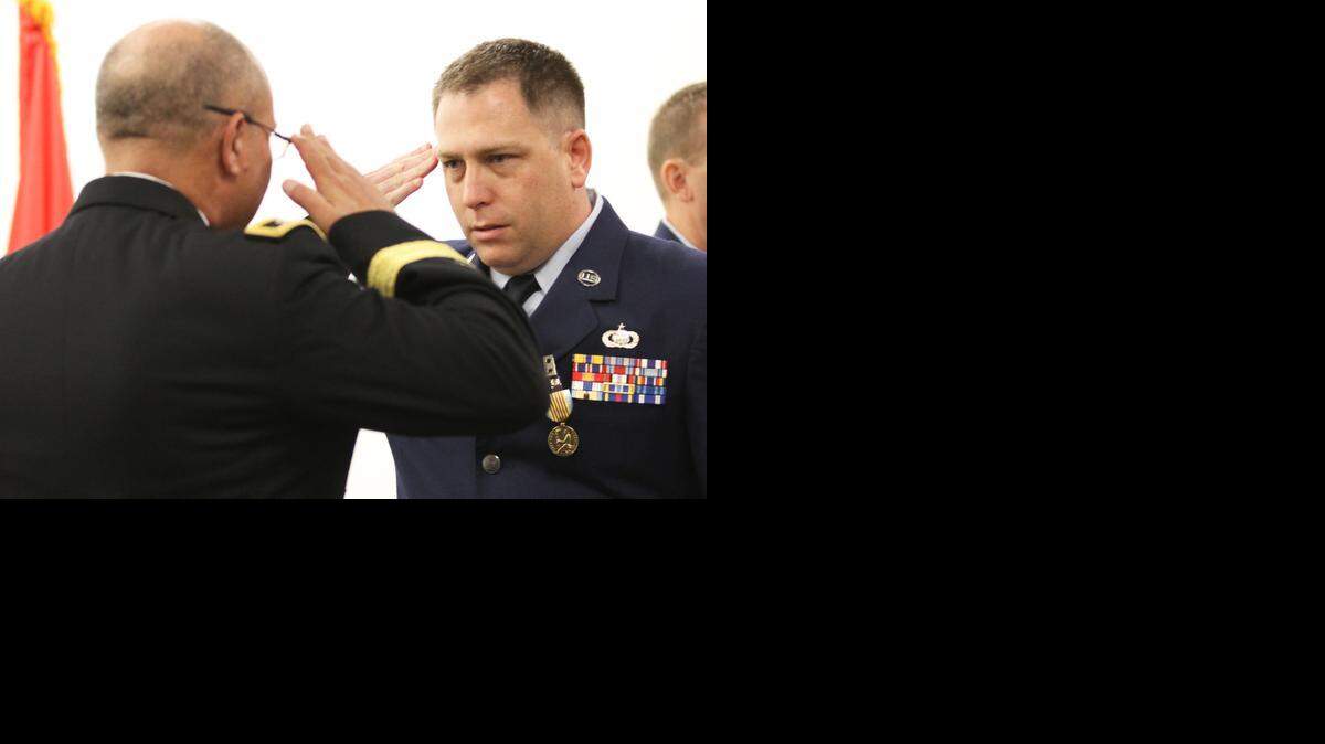 
Maj. Gen. Lee Tafanelli, left, the Kansas adjutant general, salutes Tech. Sgt. Shawn Rucker of the Kansas National Guard during a Monday morning ceremony where Rucker was presented the Airman’s Medal for steps he took to help two individuals and save another from a house fire almost two years ago.
