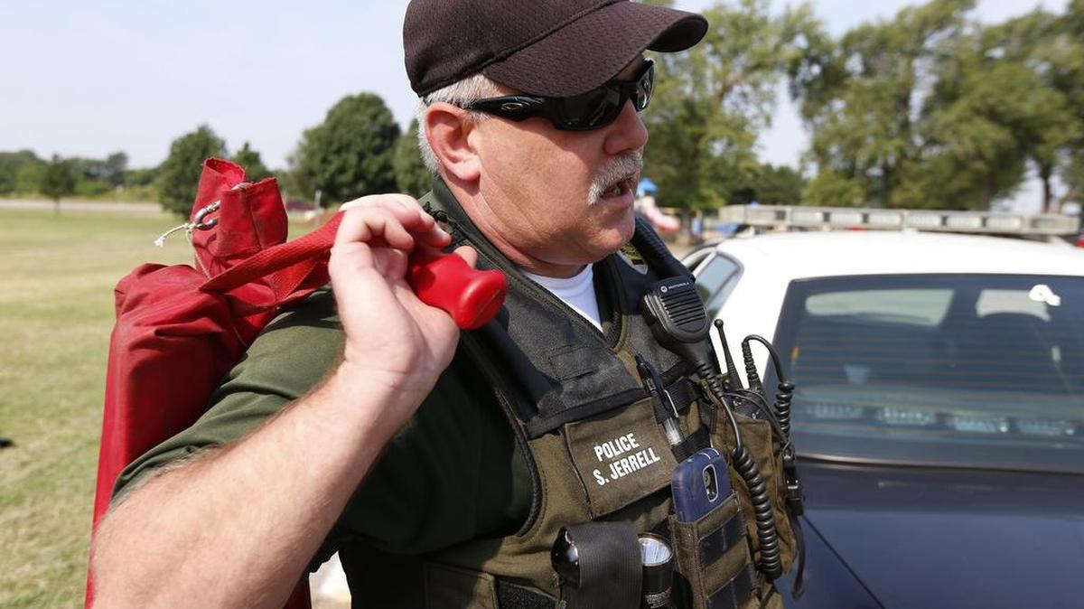 
Wichita police Officer Steve Jerrell demonstrates the proper way to deploy and retrieve spike strips. At the Law Enforcement Training Center, officers are trained on safely deploying the strips. The strips are bundled in a nylon bag. (Aug. 27, 2015)
