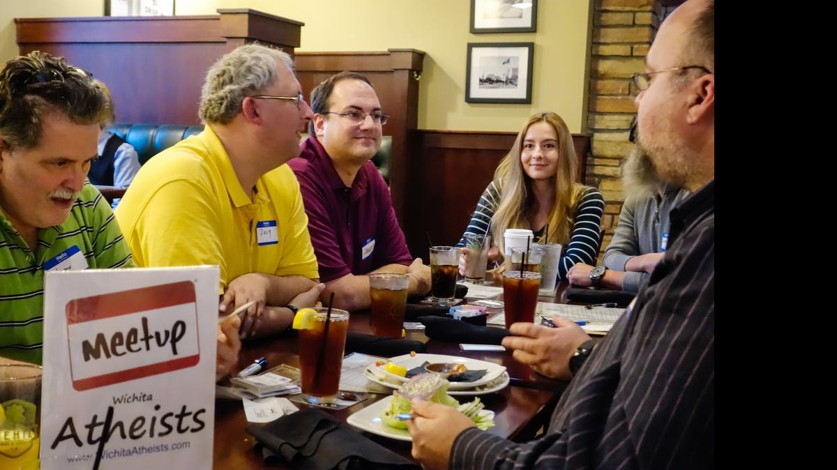 
Marta Pena, 32, (end of table) is one of an increasing number of millenials who don’t identify with a religion. She attends a local atheist club because she said it reminds her of Germany, her home country, where religion is less important. 
