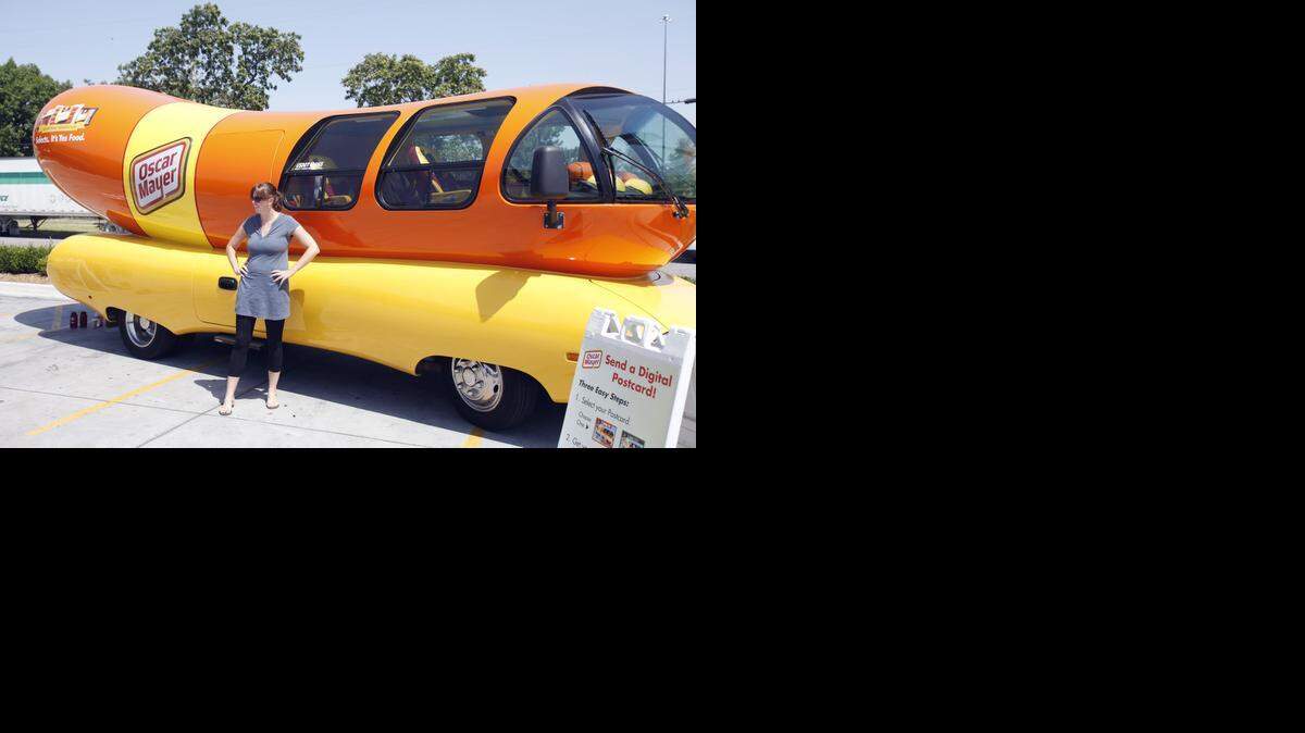 
Jessica Schlageck poses for a photo in front of the Wienermobile at QuikTrip near Kellogg and Hillside. (July 18, 2012)
