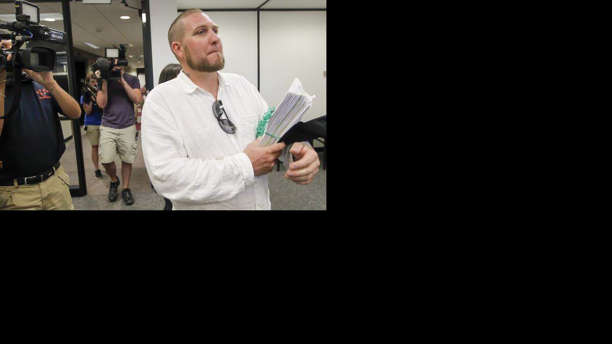 
Esau Freeman, president and co-founder of Kansas for Change, walks into the City Clerk’s Office at City Hall in July with 5,800 signed petitions calling for the decriminalization of marijuana. Supporters of decriminalizing marijuana in Wichita are getting closer to having a new petition to circulate. Freeman has been in talks with city officials about the wording of the new petition. 
