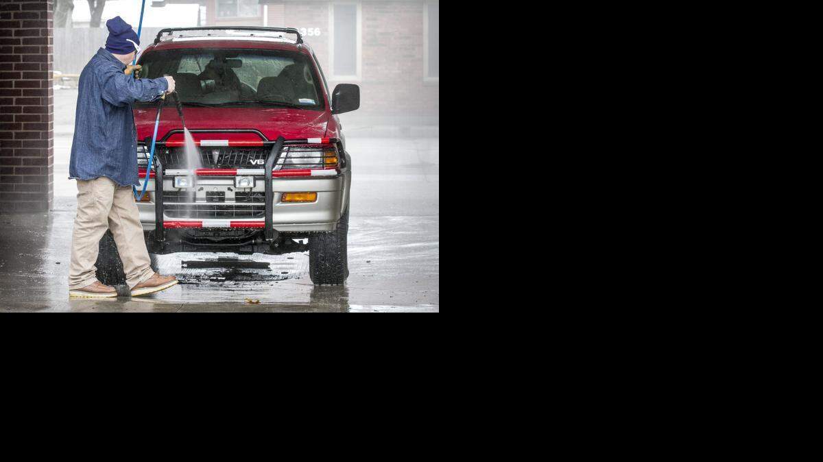 
Austin Brookes washes his SUV. (Dec. 19, 2014)
