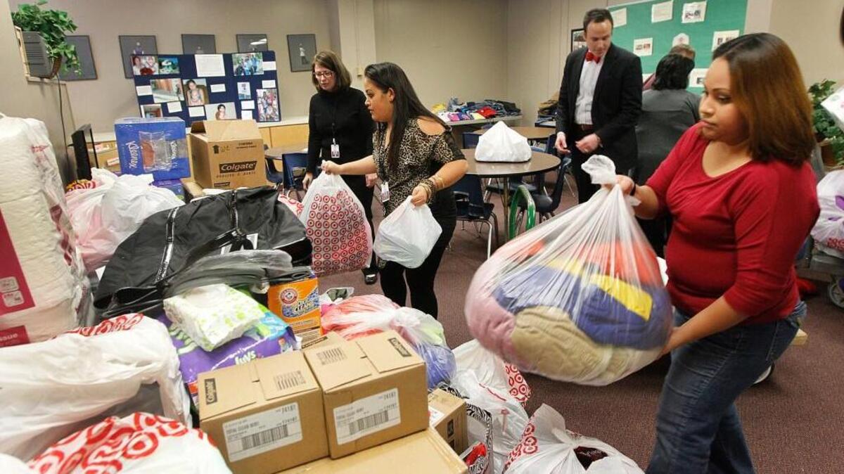 Employees with the USD 259 McKinney-Vento homeless program unload donations in 2013. Social service agencies in Wichita have decided to focus more on helping homeless young people and families.