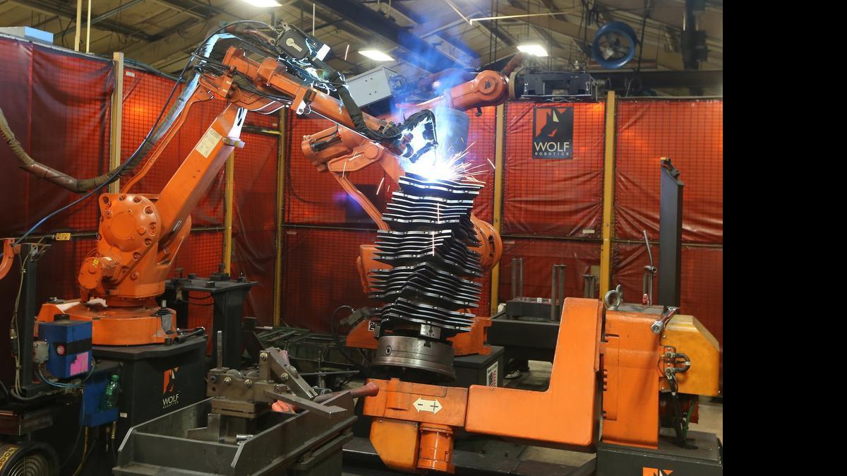
A robot welds multiple chopper blades onto a part at AGCO in Hesston.
