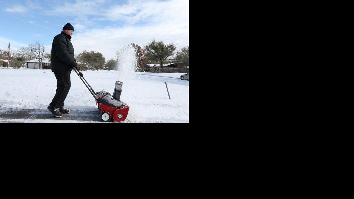 
Chester Kralicek clears a sidewalk on South Seneca on Sunday. (Nov. 16, 2014)
