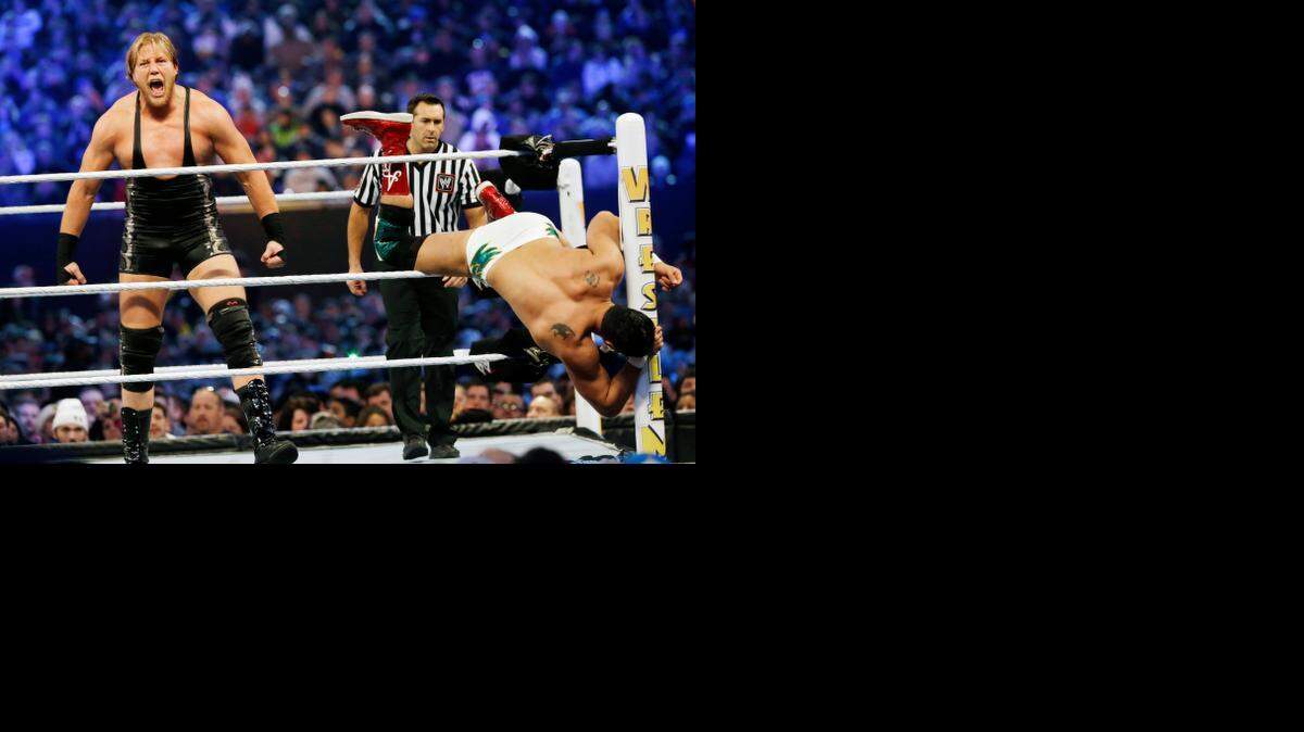 
Jacob “Jake” Hager Jr., left, known as “Jack Swagger,” shouts after throwing Jose Alberto Rodriguez of Mexico, known as “Alberto Del Rio,” partially out of the ring as they wrestle in 2013 in East Rutherford, N.J., during the WWE Wrestlemania 29 event. 
