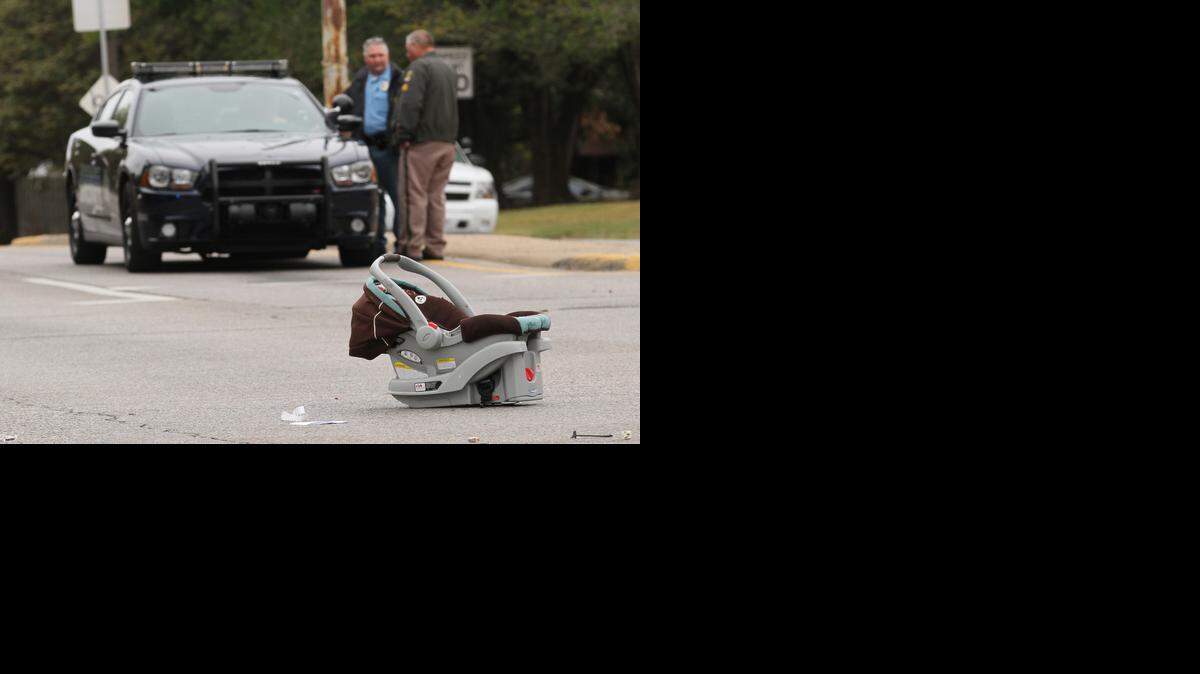 
A child’s car seat sits in the intersection of Pawnee and George Washington Boulevard on Tuesday morning after it was removed from a car that struck another car police were pursuing at the time of the crash around 8 a.m. (Nov. 4, 2014)
