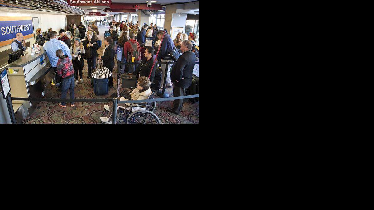 
Air travelers line up for tickets and to check their luggage at Mid Continent Airport Wednesday, Nov. 13, 2013. A Wichita State University professor and co-author of the Airline Quality Rating said Monday he’s forecasting tighter seating, higher travel costs and more uncertainty for airline travel over this holiday season.

