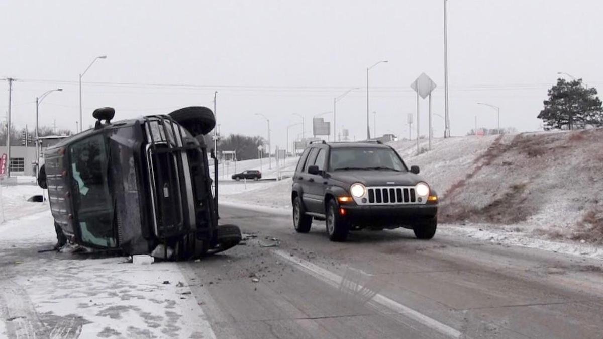An overturned pickup truck rests on its side after skidding off of I-235 near Central Ave early Monday morning. Early Morning freezing rain and snow turned I-235 into a virtual ice rink. (January 15, 2018)