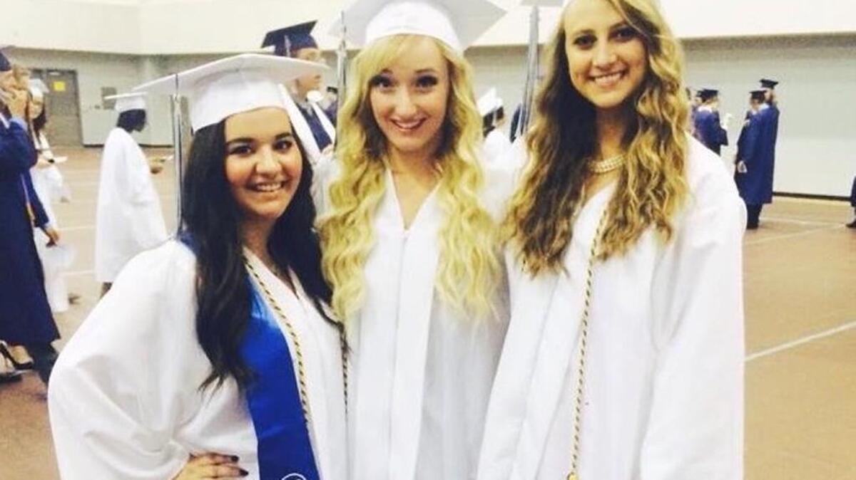 Toni Anderson, middle, poses with friends Roxy Townsend, left, and Carly Prior at their East High commencement ceremony in 2014.