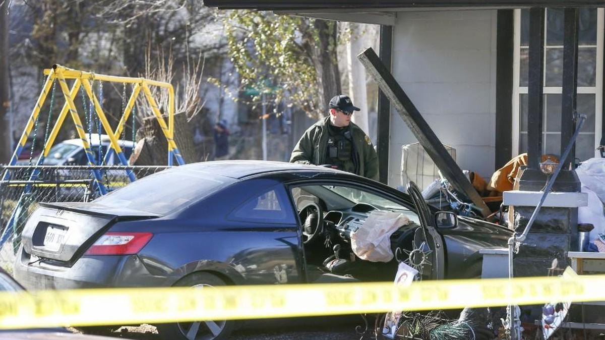 Wichita police investigate where a car crashed into a house on the corner of Ellis and Indianapolis on Wednesday afternoon. (Dec. 14, 2016)