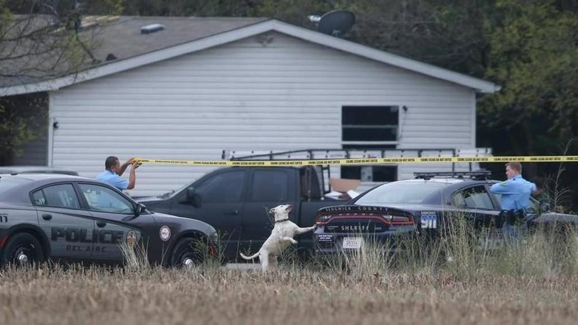 Sedgwick County Sheriff’s Office deputies string up crime scene tape at the scene of a shooting near Valley Center on Saturday. (April 1, 2017)