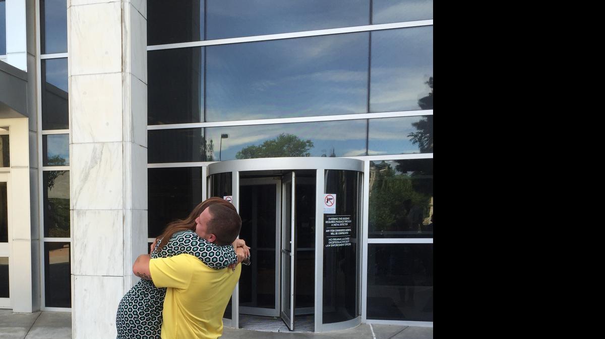 
Kyler Carriker embraces his attorney, Sarah Swain, outside the Sedgwick County Courthouse after he was found not guilty of felony murder on Thursday.
