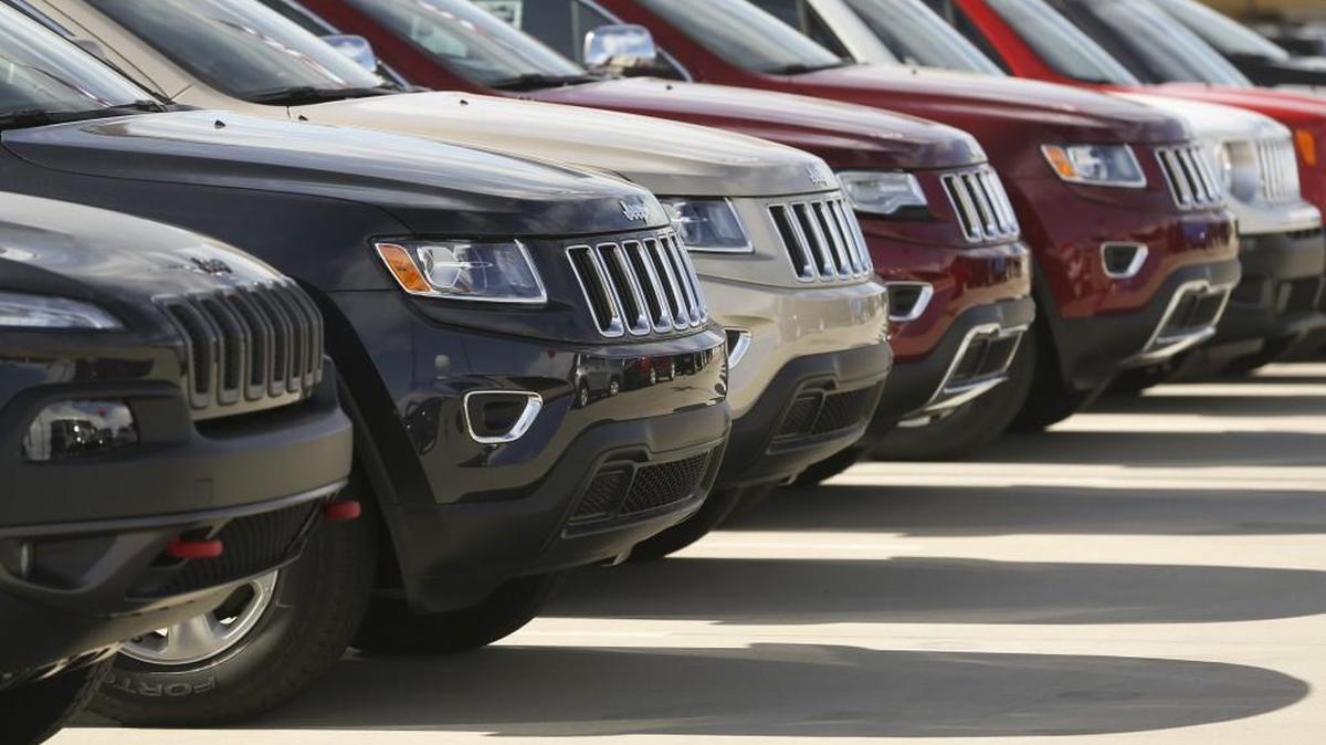 A row of cars lined up at a Wichit auto dealership.