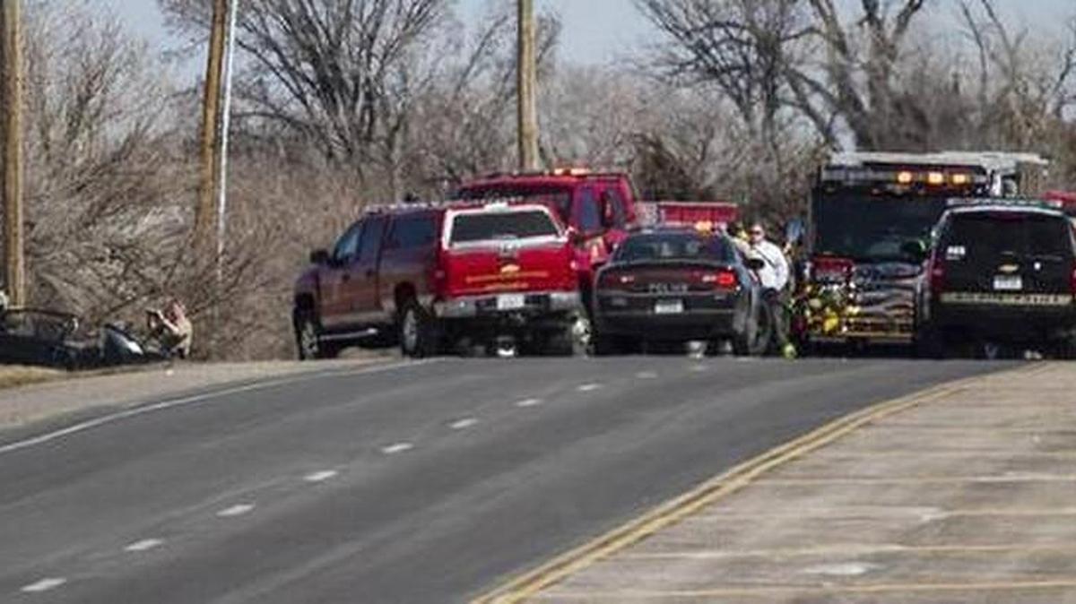 Wichita and Sedgwick County officers investigate the scene of a fatal single-car crash near Pawnee and Woodlawn on March 11, 2015. A black Monte Carlo left the roadway around 1 p.m. and struck a utility pole. Two people died and two more suffered potentially serious injuries.