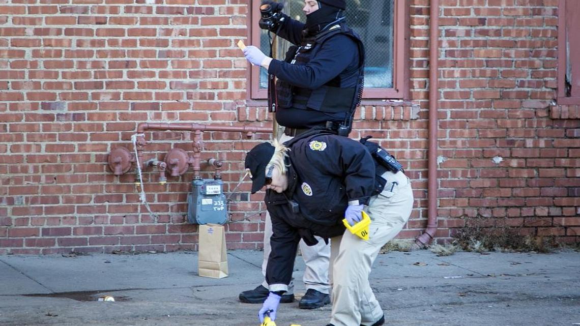 Wichita Police crime-scene investigators record evidence following an overnight shooting near Lincoln and Broadway, on Friday morning, Jan. 1, 2016.