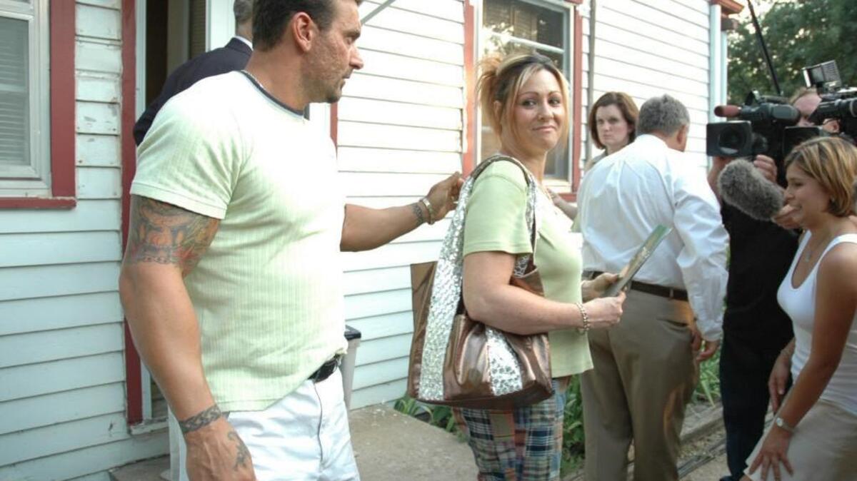 Michelle Borin, center, prepares to give a statement to reporters after purchasing the house owned by Dennis and Paula Rader in 2005.