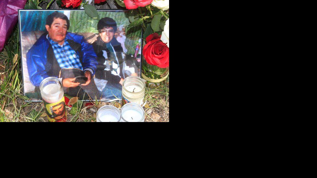
A photo of homicide victims Godofredo and Martha Moreno are among the candles and flowers left at a memorial in front of their home on South Ida where they were found murdered last Thursday. (Oct. 20, 2014)
