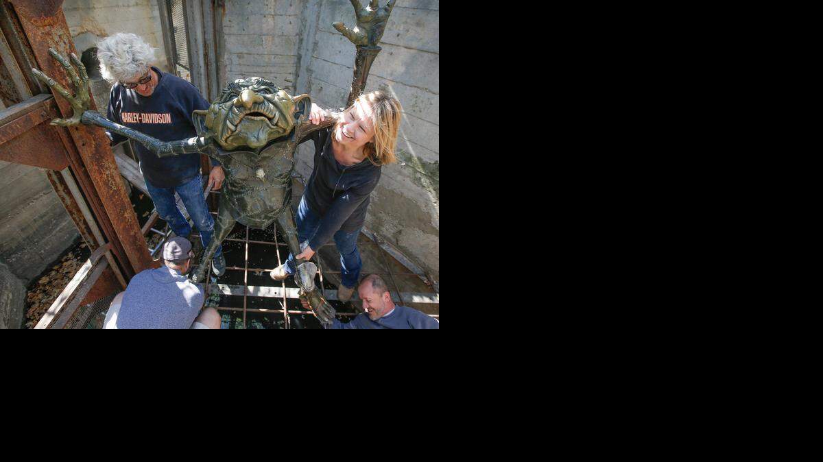 
Artist Constance Ernst, right, along with Chris Brunner, upper left, Marc Durfee, bottom left, and Randy Regier return a troll sculpture to its original location in April.
