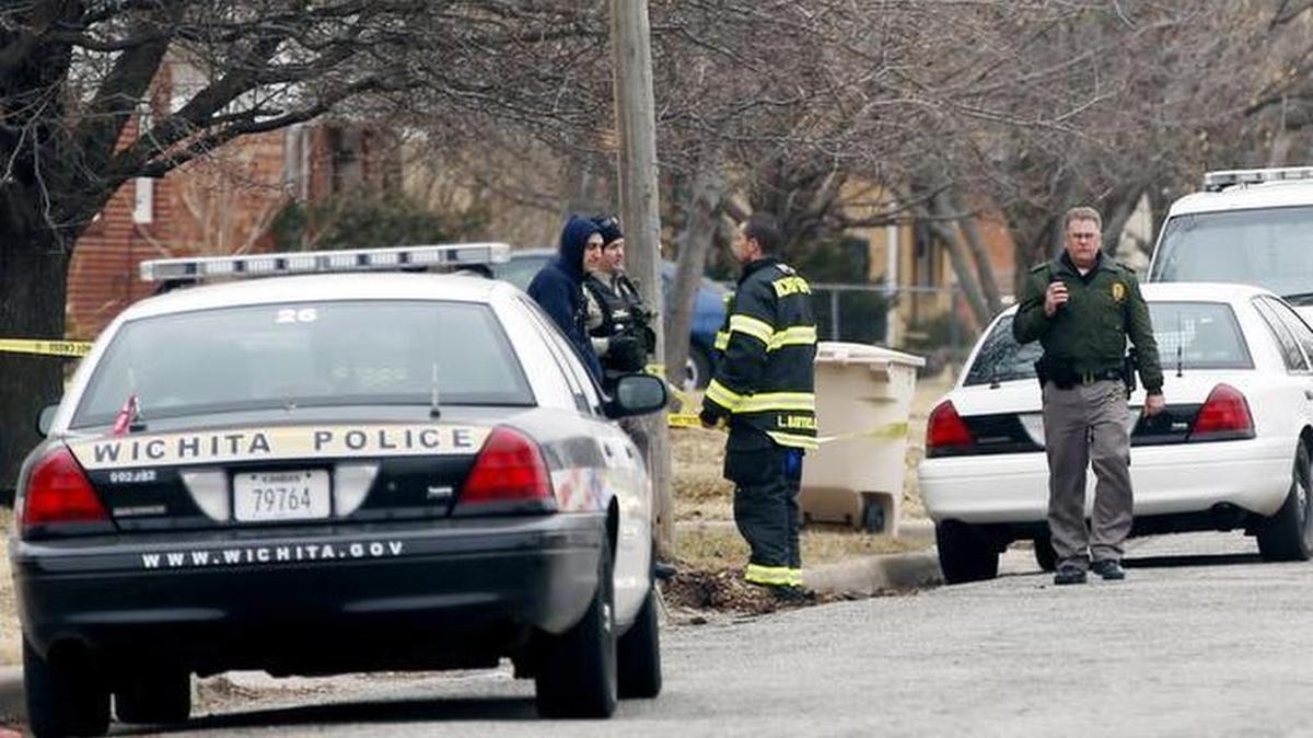 
Police officers investigate a shooting in the 2300 block of West Graber on Feb. 25, 2014.
