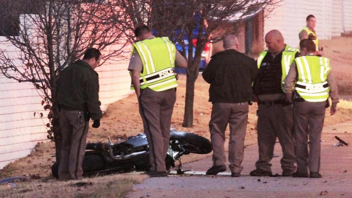 Wichita police officers look at one of the two motorcycles involved in a fatal crash with a truck on Pawnee near Cooper in southeast Wichita. (Dec. 16, 2013)