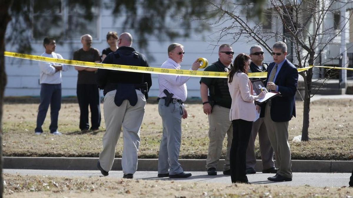Police and sheriff’s officers investigate the scene at Kinkaid and Topeka on Tuesday afternoon after an officer was struck by a car driven by a felony suspect. (Feb. 7, 2017)