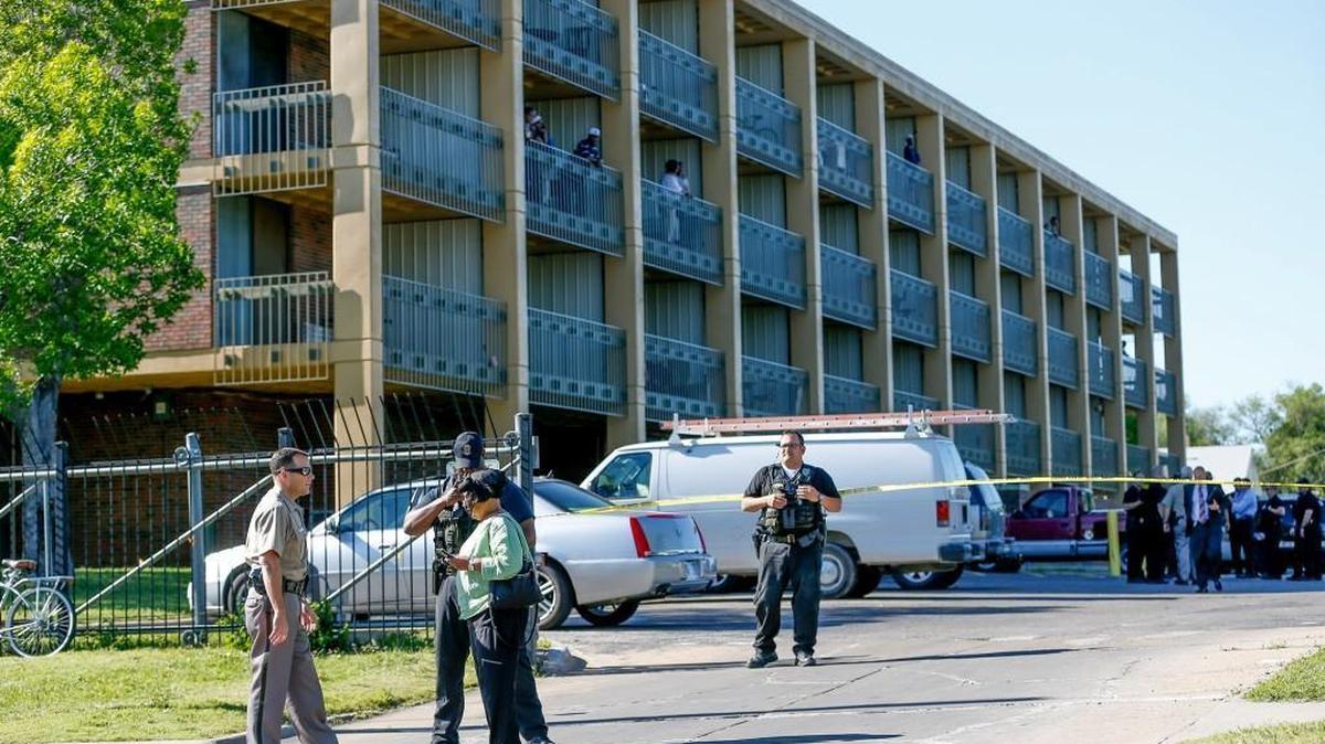 A resident talks with Wichita Police Chief Gordon Ramsay, left, and another police officer at the scene of a fatal shooting at Calvary Towers at 25th and Grove. (May 4, 2016)