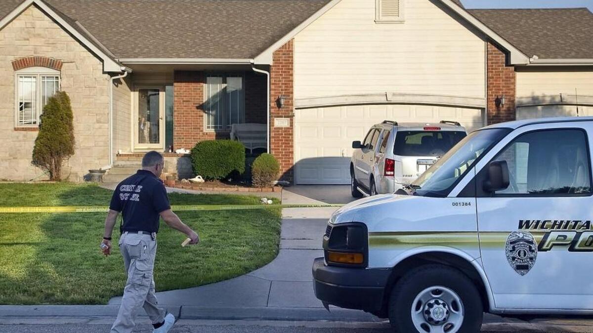 A Wichita police crime scene investigator enters 2207 S. Beech. (June 24, 2014)