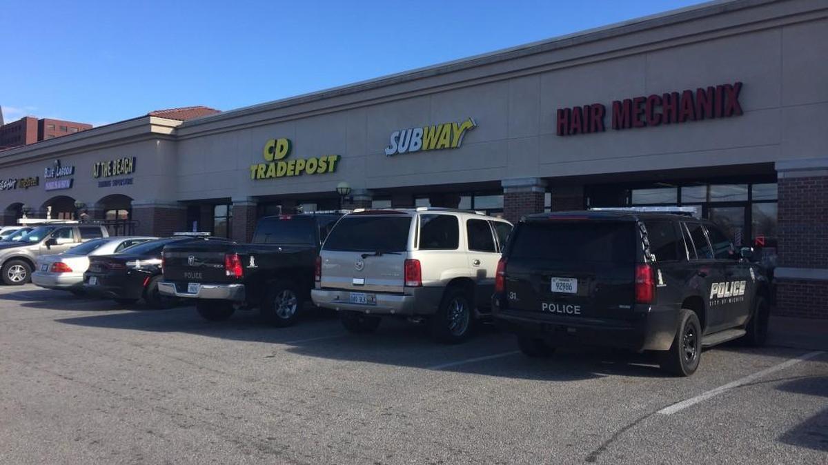 Police vehicles are seen parked outside the Subway shop in College Hill Square in east Wichita on Wednesday after a report of a robbery there. (Jan. 18, 2017)