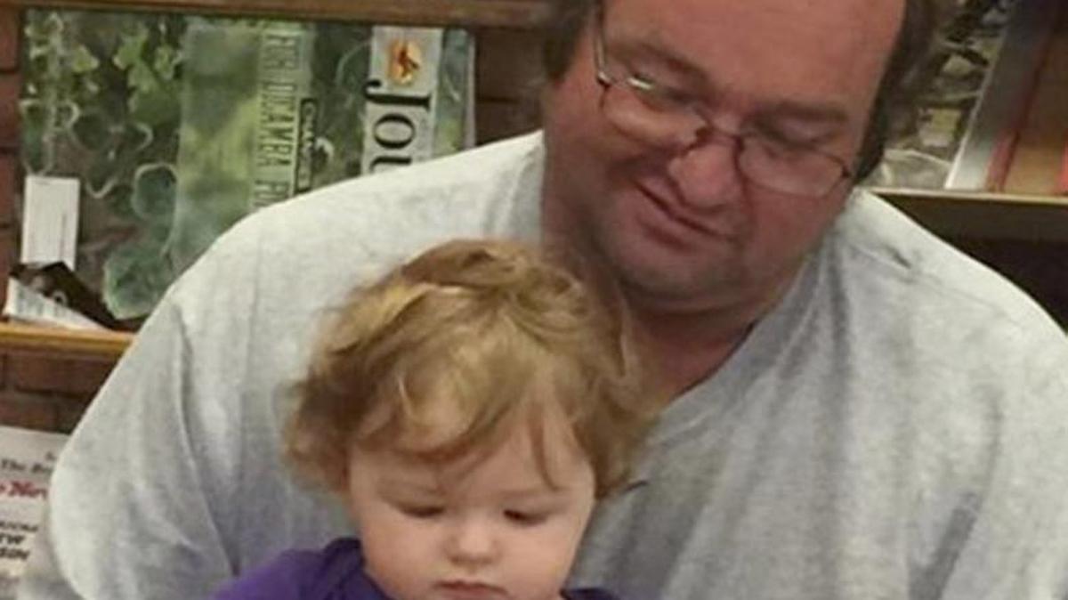 Steven Myers reads a book to his daughter Kaylee in this photo provided by the family.