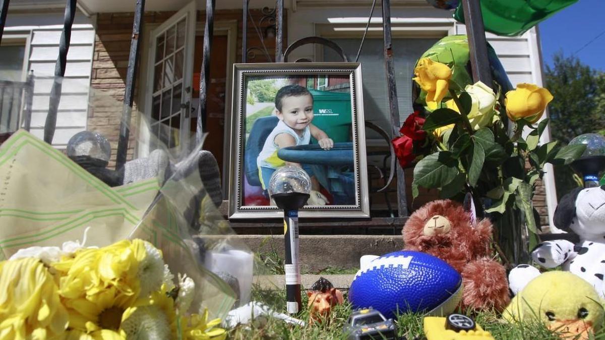 A memorial to 3-year-old Evan Brewer sits in front of the house at 2037 S. Vine where his body was found in early September.