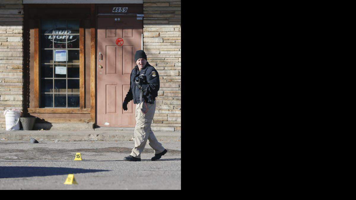 
Crime scene investigators processes a scene at the Place, 4859 E. Harry. Two people have been confirmed dead and two others wounded after a shooting over night shooting at the bar. (Jan. 10, 2015)
