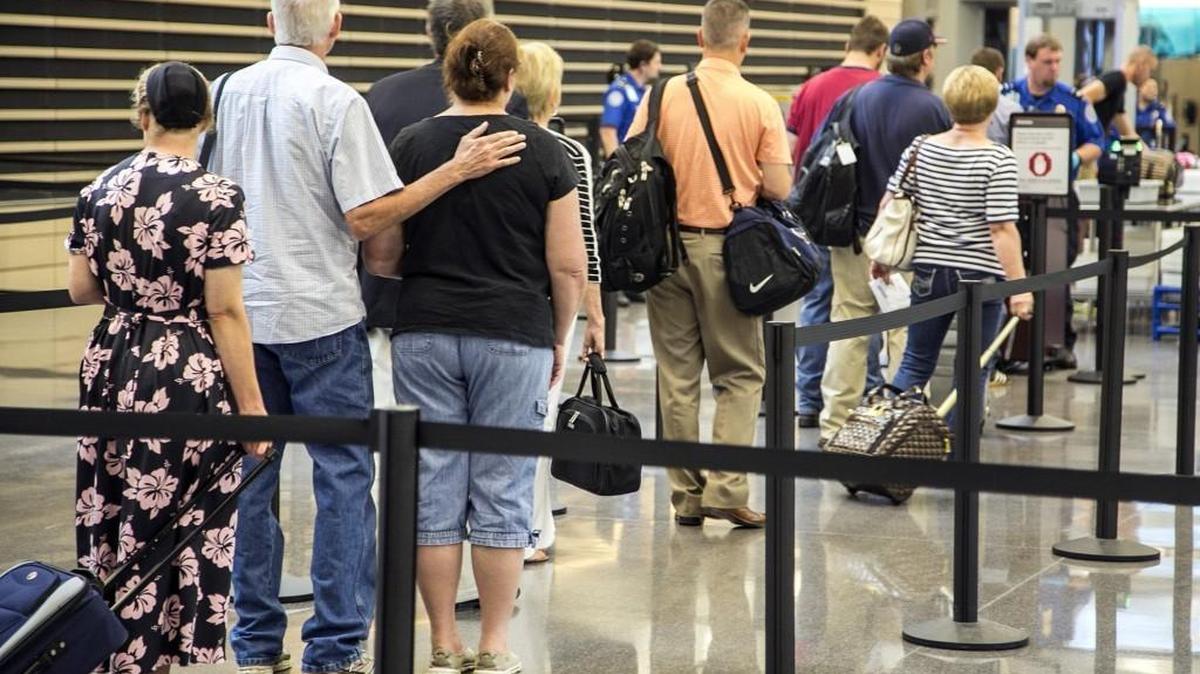 Travelers line up at the Transportation Security Administration checkpoint in the Wichita Eisenhower National Airport. An 82-year-old woman was arrested this week after a scuffle at the airport with a TSA officer.