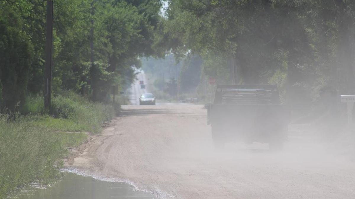 A truck on Tuesday passes through where Grant Burris was struck in a hit-and-run collision near Haysville on May 12. (May 24, 2016)