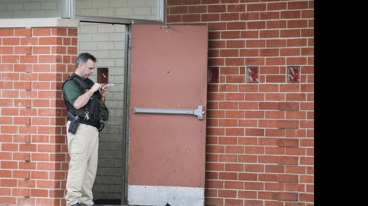 
A Wichita Police officer stands outside the entrance of a venue where a 17-year-old teenager died in a shooting early Saturday morning.

