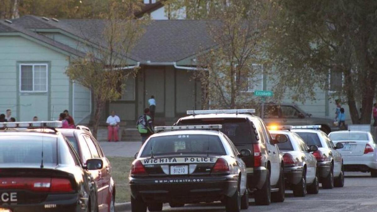 Wichita police officers investigate after a woman was found with a gunshot wound inside a car in the 1300 block of West 42nd Street South on Wednesday. (Oct. 28, 2015)