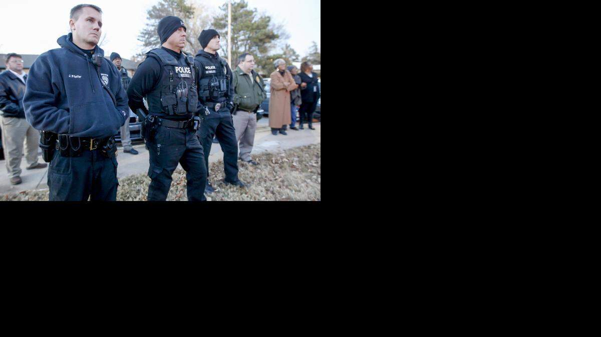 
Officers and residents listen Wednesday during a neighborhood meeting to a police briefing about the woman who was sexually assaulted and set on fire Friday in Fairmount Park. (Nov. 19, 2014)
