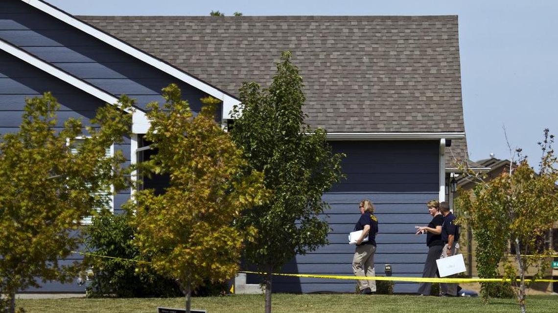 Investigators enter a house in the 2500 block of North Woodridge after a homicide was reported. (Sept. 9, 2011)