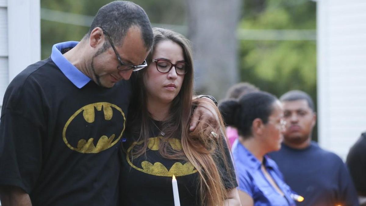 Carlo Brewer and his wife, Sara, hug during a vigil for Carlo's son Evan Brewer in front of the house where the 3-year-old child’s body was found.